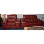 A contemporary red leather two seater settee with matching armchair,