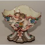 A KPM figural bowl, decorated with winged putti and foliage, stamped KPM to base, also stamped '386,