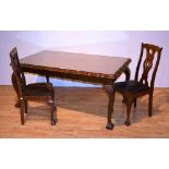 A Chippendale style walnut rectangular dining table with six walnut dining chairs,