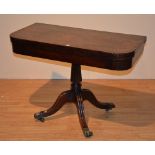 A 19th century Regency mahogany fold over tea table, the swivel top,