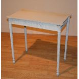 A painted side table in the Regency style, raised on reeded tapering supports,