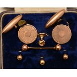 A pair of 9ct gold cufflinks, the round ends with engine turned decoration,