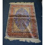 A Persian silk rug/wall hanging, the navy floral motif to centre over cream ground,