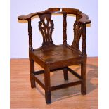 A 19th century country style ash and elm corner chair, with pierced splats,