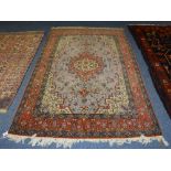 An Eastern rug, the central floral medallion on pale blue ground,