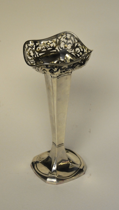 A silver posy vase, with pierced foliate top over tapering column and circular foot,