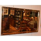 A large reproduction wall mirror, with gilt border,
