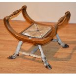 A camel stool, framed in oak,
