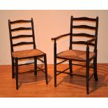 A set of eight country style oak ladder back rush seated dining chairs,