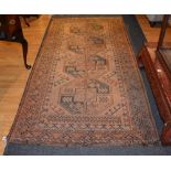 An Eastern rug, with four central medallions on pale brown ground,