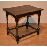 An antique yew wood country style side table, raised on bobbin twist supports,