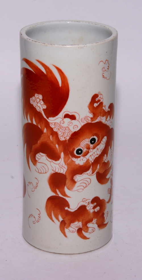 A Chinese cylindrical vase, decorated with orange shi-shi dogs on white ground,