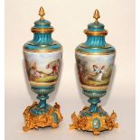A pair of good quality French enamel and ormolu urns with covers, of baluster form,