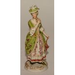 A KPM figure of a lady, in 18th century dress holding parasol and rose, stamped KPM to underside,