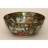 A 19th century Canton famille rose bowl, decorated with panels of figures in foliage, 27.