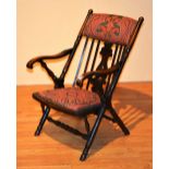 A vintage rail back armchair, with later upholstered stuffover seat and back rest,