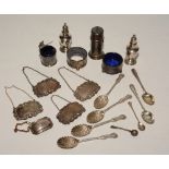 A mixed lot of silver, to include five spirit labels, pair of pepper pots, spoons and condiments,