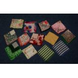 A large collection of vintage silk and chiffon pocket handkerchiefs, all of different designs,