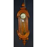 A mahogany cased wall clock of small form, with glazed door enclosing dial with Roman numerals,