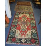 Three Eastern rugs, one with large foliate diamond over red and white ground,