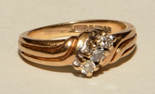 A 9ct gold three stone diamond ring, the three brilliant cut diamonds measuring approximately 0.