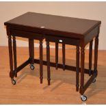 A reproduction nest of three tables, the largest table with card style fold over top,