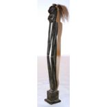 An early 20th century tall African tribal wood figure, with horsehair ponytail,