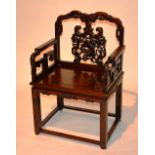 A 19th century Chinese Hongmu armchair, the carved back panel decorated with two lion dogs,