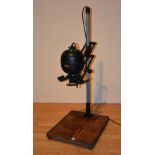 A vintage Leitz photo enlarger with Zeiss Tessar lens, raised on plinth,
