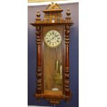 An early 20th century walnut cased Vienna wall clock signed by Gustav Becker,