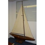 A Victorian pond yacht, with linen sails, raised on plinth,