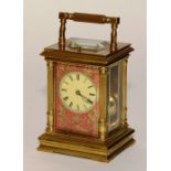 A French brass repeater carriage clock circa 1900, the cream enamel dial with Roman numerals,