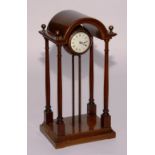 A French walnut four pillar orb clock, with mottled marble orb casing,