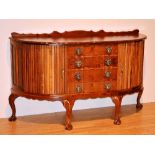 A walnut sideboard in the style of Chippendale, with four graduated drawers,