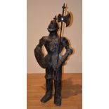 A reproduction floor standing metal figure of a knight,