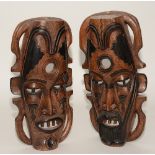 A pair of Nigerian wall masks, featuring male and female,