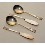 A boxed set of silver preserve spoons and butter knives, comprising two knives and two spoons,