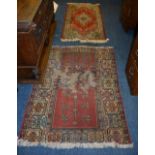 A machine made Keshan rug, decorated with central motif on red ground, 191 x 90cm,