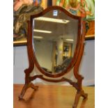 A Regency style mahogany shield shaped dressing mirror,