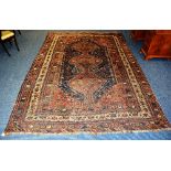 A large Persian carpet, with three central diamonds over navy ground,