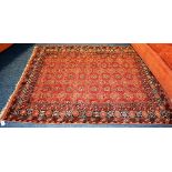 A Turkoman rug, the allover foliate motifs over red ground, with multiple geometric borders,