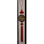 A Chinese brass, jade and hardwood lucky charm plaque with tassel,