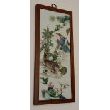 A Chinese famille rose wall panel, decorated with grotesque male and dog in foliage,