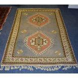 A Turkish Kars rug, with two central geometric diamond motifs over pale blue ground,