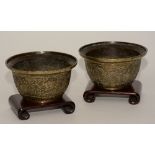 A pair of Chinese brass bowls/incense burners on hardwood stands,