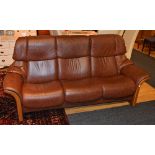 A stressless reclining brown leather three seater sofa by Ekorness,