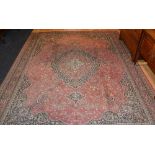 A large Wilton carpet, with allover floral decoration on red ground,
