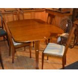 An Arts & Crafts style oak drop leaf table with four rail back dining chairs,