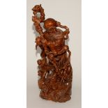 A large Chinese hardwood figure group, in the form of an ancient god,