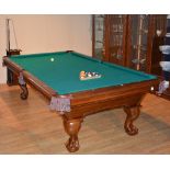 An American 8½ ft pool table with slate bed by Brunswick, to include balls, cues,
